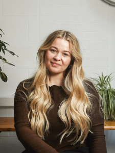 female singing teacher smiling at camera