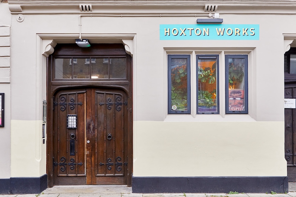 Singing school old wooden doors on London building with turquoise sign saying Hoxton Works