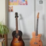 two guitars in stands in singing school