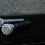 two microphones laying on top of piano