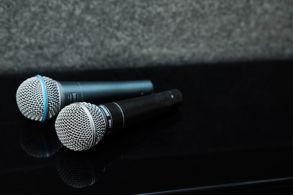 two microphones laying on top of piano