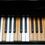 old piano keys, some discoloured where ivories have worn