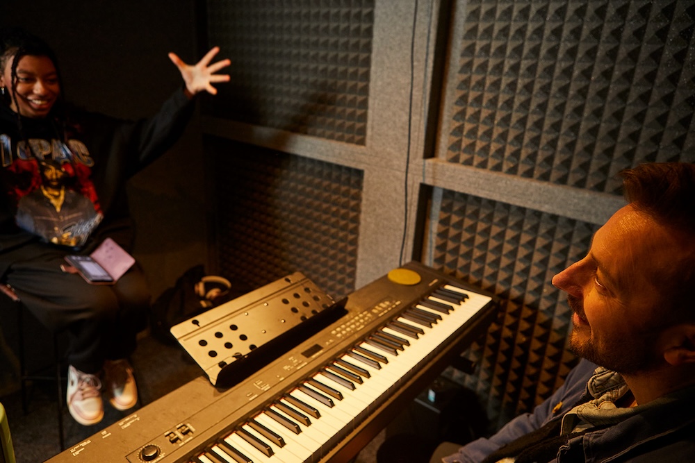 student singing during singing lesson in sound booth